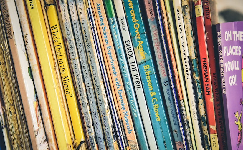 Children's books lined up in a row.